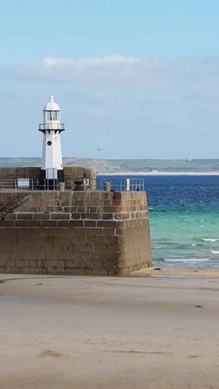 The lighthouse and beach at St Ives harbour